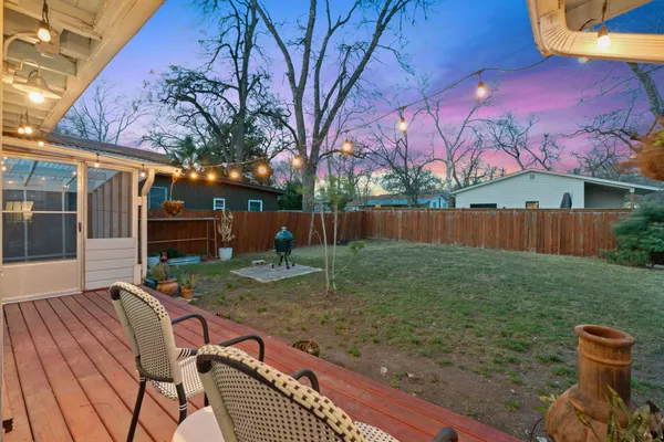 a backyard of a house with table and chairs