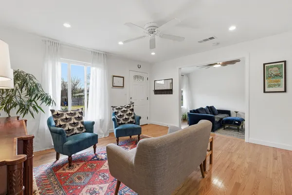a living room with furniture and a chandelier