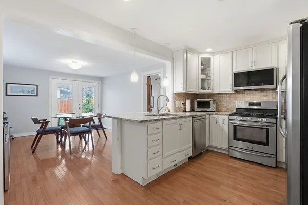 a kitchen with a white cabinets and appliances