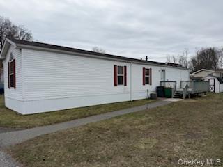 115 Winding Wood Road Hopewell Junction, NY 12533 - Photo 15 of 17 a view of a white house with a yard