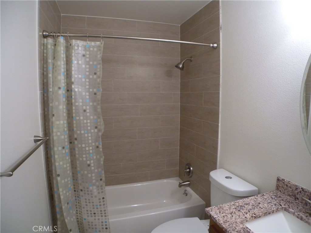 21632 Brookhurst Street, Unit B Huntington Beach, CA 92646 - Photo 11 of 17 a bathroom with a shower and a toilet