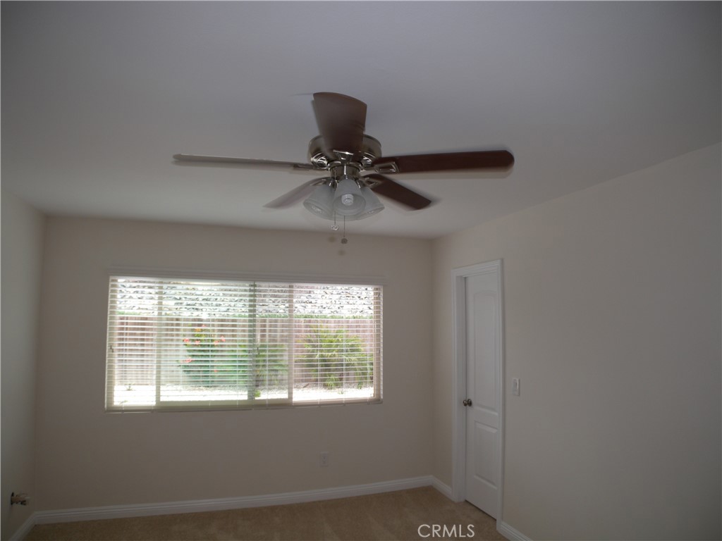 21632 Brookhurst Street, Unit B Huntington Beach, CA 92646 - Photo 13 of 17 a room with a window and a ceiling fan
