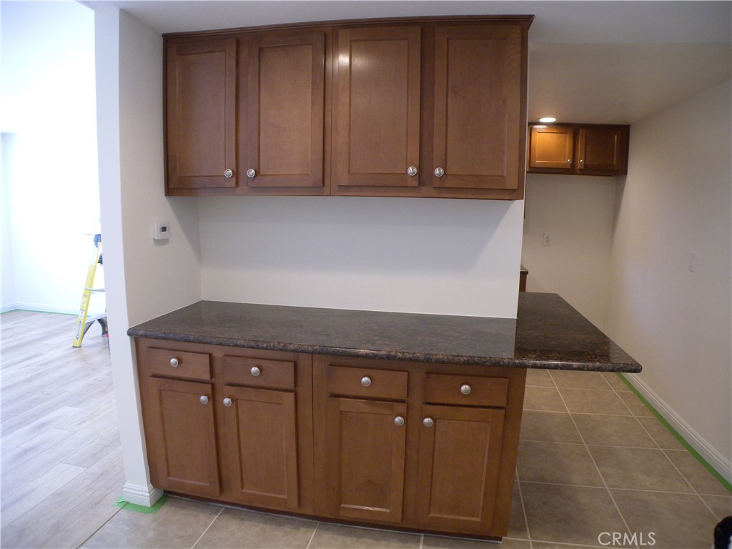 21632 Brookhurst Street, Unit B Huntington Beach, CA 92646 - Photo 7 of 17 a view of a kitchen with granite countertop cabinets