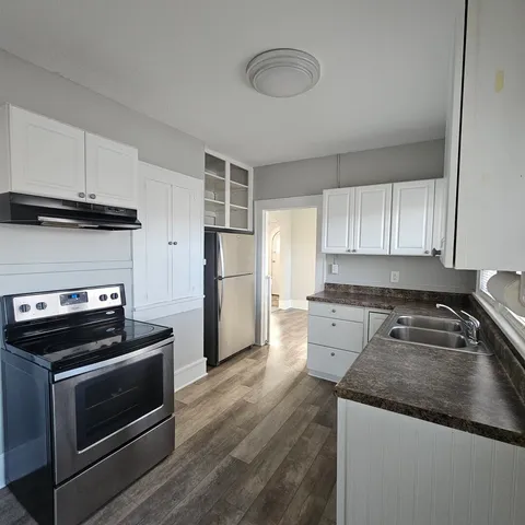 a kitchen with a refrigerator stove and sink