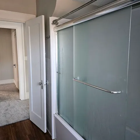 a bathroom with a glass door shower