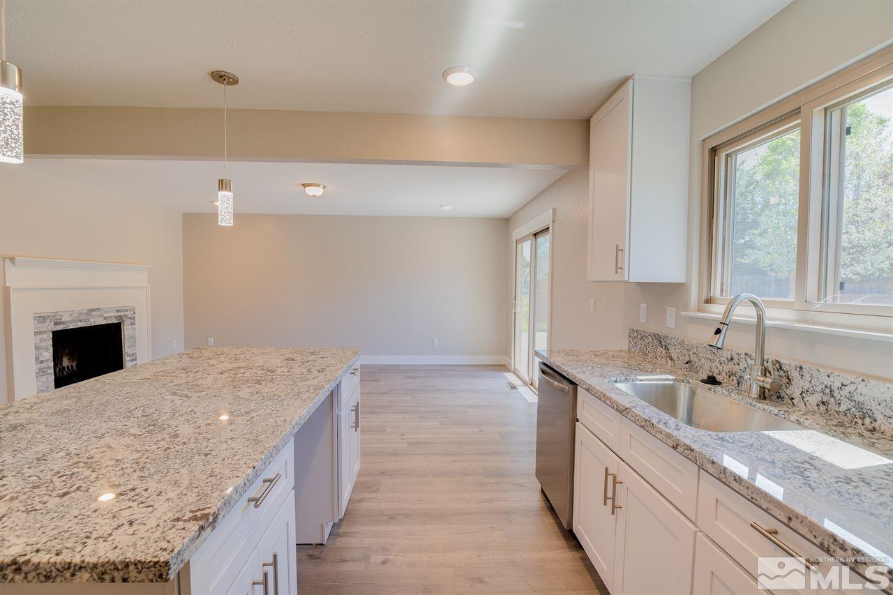 10050 Broken Hill Road Reno, NV 89511 - Photo 8 of 23 a spacious bathroom with a granite countertop sink a large mirror and a bathtub