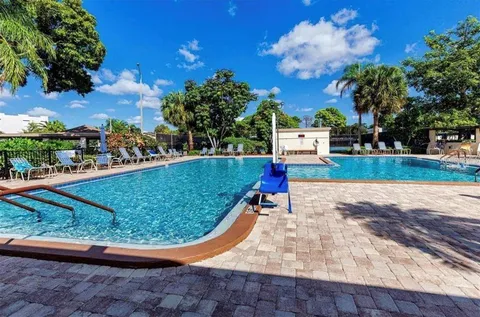 a view of a swimming pool with a yard