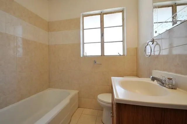 a bathroom with a sink a bathtub and window