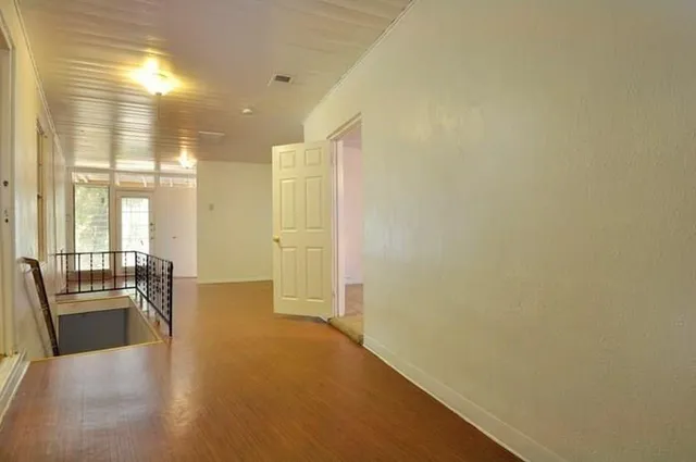 a view of a hallway with a living room