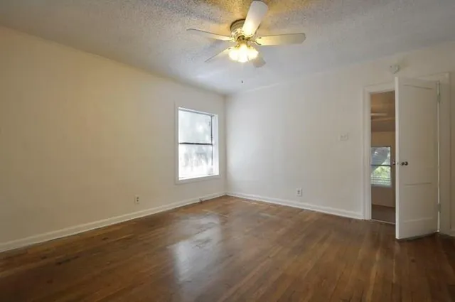 wooden floor in an empty room with a window