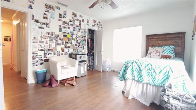 a bedroom with furniture and a wooden floor