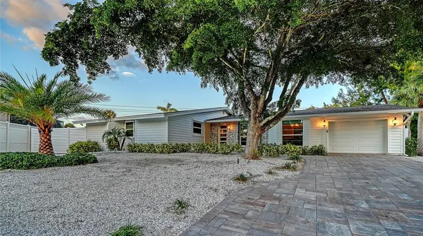 a front view of house with yard and trees