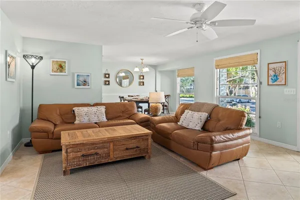 a living room with furniture and a dining table