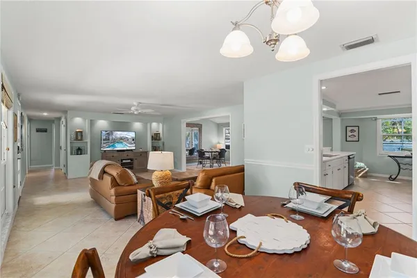 a view of a dining room with furniture and chandelier