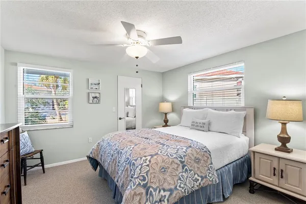 a bedroom with a bed couch and window