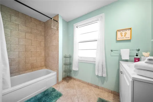 a bathroom with a double vanity sink and mirror with shower