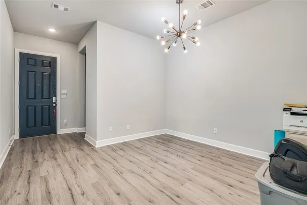 a view of a room with wooden floor