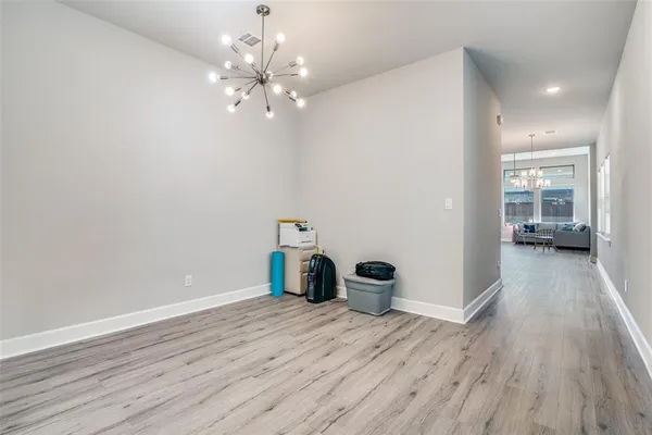 a view of a room with wooden floor