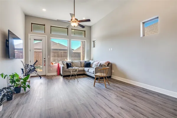 a living room with furniture and a wooden floor