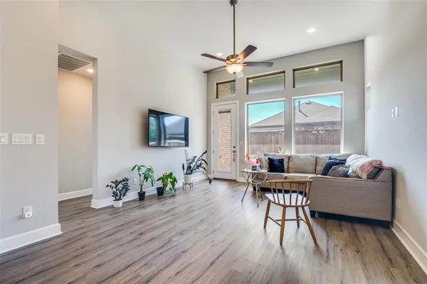 a living room with furniture wooden floor and a window