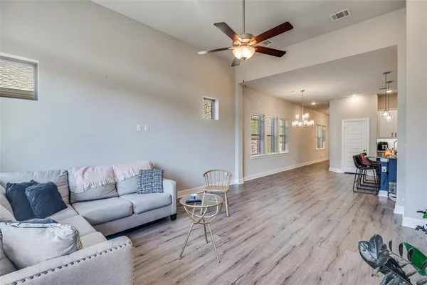 a living room with furniture and a wooden floor