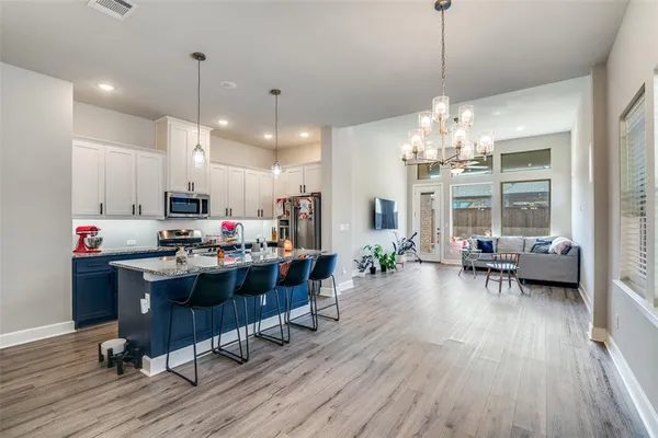 a view of a dining room with furniture wooden floor and chandelier
