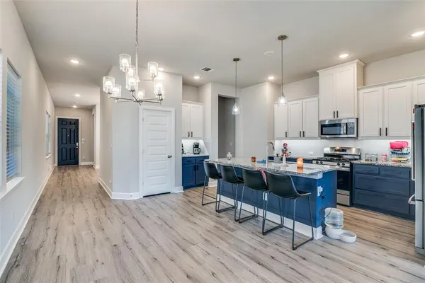 a view of a dining room with furniture wooden floor and chandelier