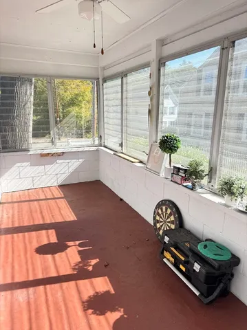a bedroom with a bed and a flat tv screen on dresser