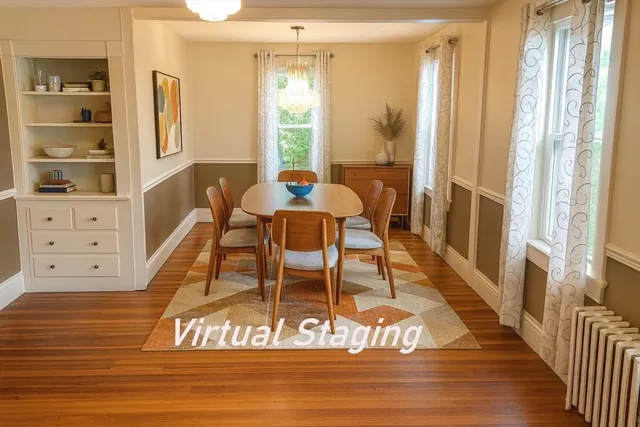 a dining room with wooden floor a chandelier a wooden table and chairs