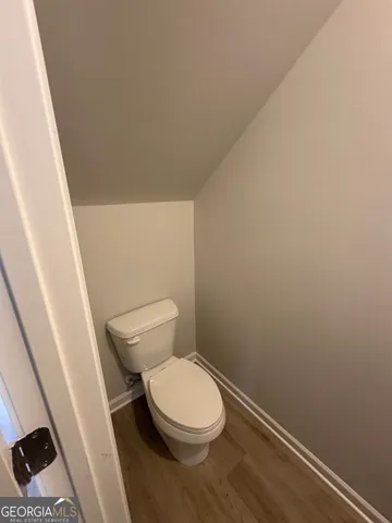 a white toilet sitting next to a sink