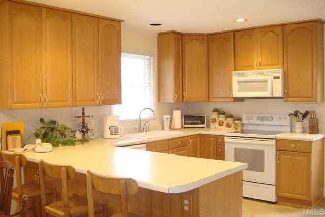 3309 Harden Road Raleigh, NC 27607 - Photo 4 of 10 a kitchen with a sink cabinets and window