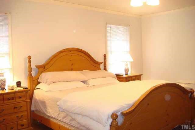 3309 Harden Road Raleigh, NC 27607 - Photo 6 of 10 a large bed sitting in a bedroom next to a window