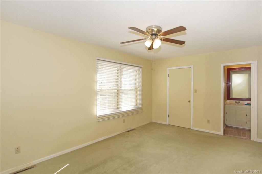 206 Sycamore Road Salisbury, NC 28147 - Photo 22 of 41 a view of an empty room with chandelier fan and a window