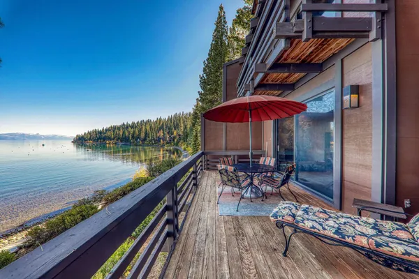 a view of a lake with a table and chairs