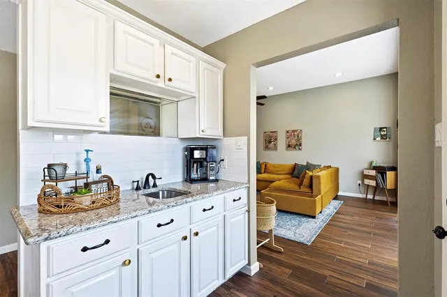 a kitchen with stainless steel appliances granite countertop a sink and cabinets