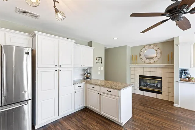 a open kitchen with white cabinets and stainless steel appliances