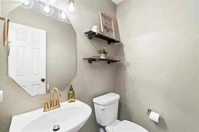 a spacious bedroom with a bed and a chandelier
