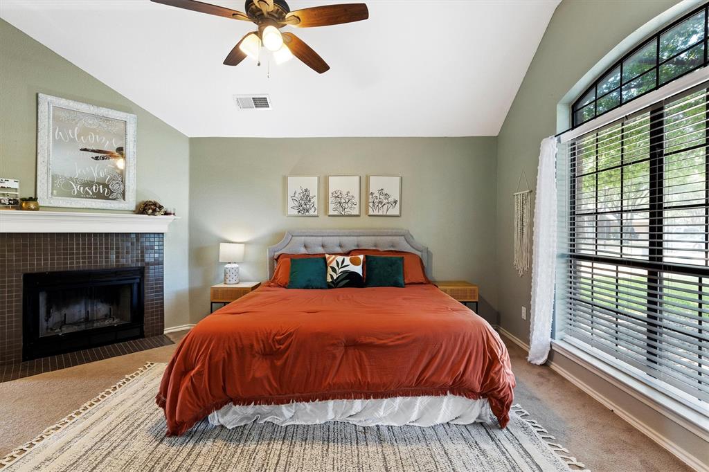 800 Short Line Boulevard Midlothian, TX 76065 - Photo 20 of 39 a bedroom with a bed and a fireplace