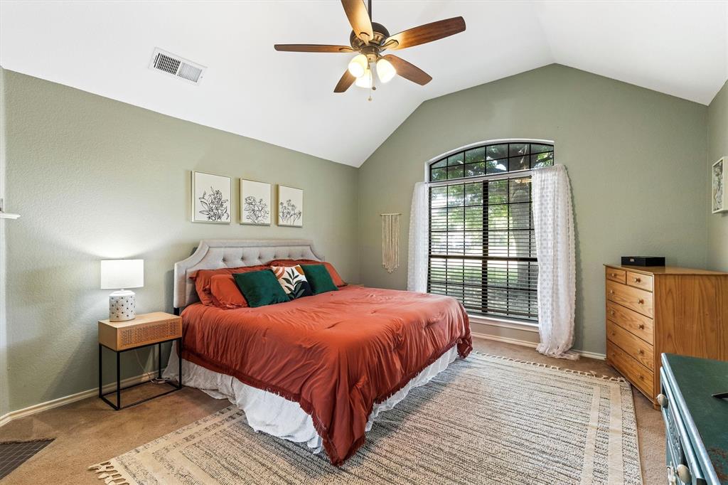 800 Short Line Boulevard Midlothian, TX 76065 - Photo 21 of 39 a bedroom with a large bed and a chandelier
