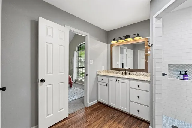 a bathroom with a double vanity sink toilet and mirror