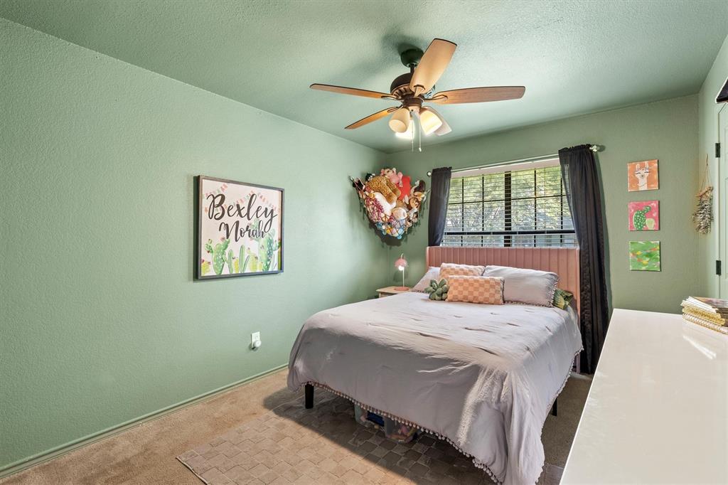 800 Short Line Boulevard Midlothian, TX 76065 - Photo 27 of 39 a bedroom with a bed and a chandelier