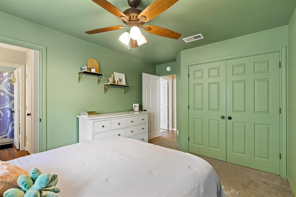 800 Short Line Boulevard Midlothian, TX 76065 - Photo 28 of 39 a bedroom with a bed and a chandelier