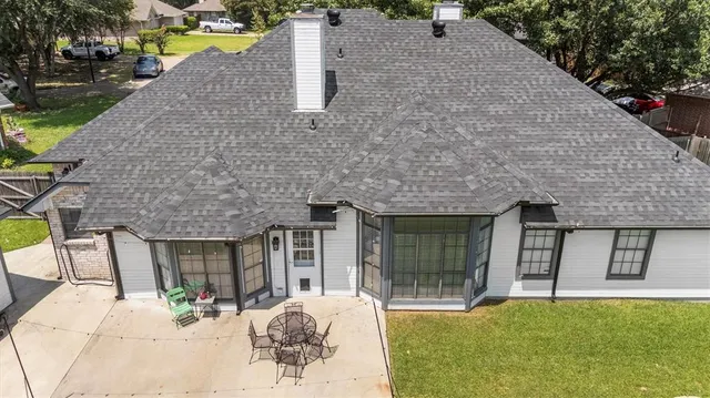 an aerial view of a house with a garden and a yard