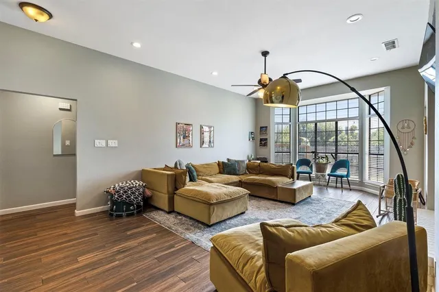 a living room with furniture and a floor to ceiling window