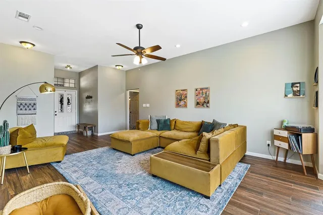 a living room with furniture and wooden floor