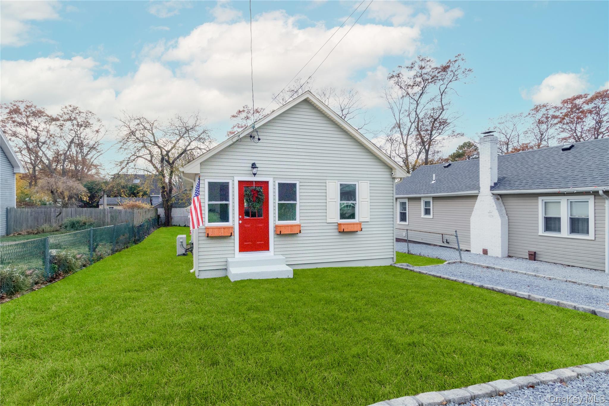 a front view of house with yard and green space