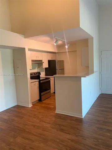 a kitchen with kitchen island wooden cabinets and stainless steel appliances