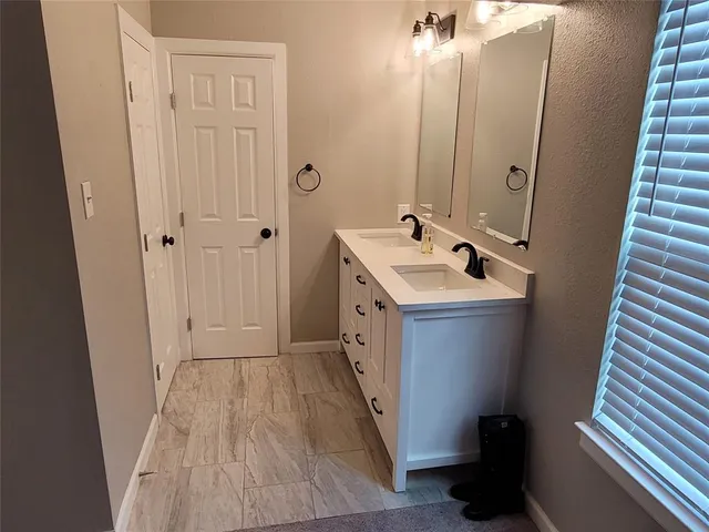 a bathroom with a sink a mirror and a toilet