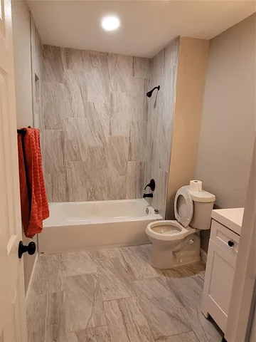 a bathroom with a toilet a sink and bathtub