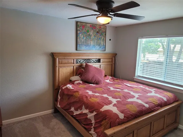 a bed sitting in a bedroom next to a window